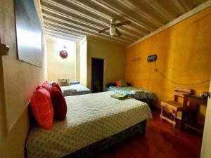 a bedroom with two beds and a ceiling fan at Hostal Las Veraneras Ataco in Concepción de Ataco