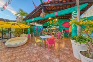 een patio met kleurrijke stoelen en tafels in een gebouw bij Casa Maria Hotel Boutique & Gallery Adults Only in Puerto Vallarta