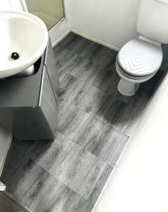 a bathroom with a sink and a toilet at Hazel grove - Withernsea Sands in Waxholme