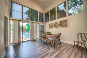 a dining room with a table and chairs and large windows at CW CH Camp Warnecke Club Haus in New Braunfels