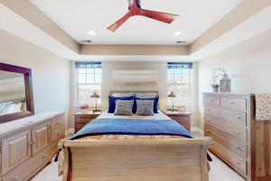 a bedroom with a large bed with blue pillows at Barber Valley Beauty in Boise