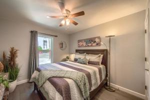 a bedroom with a bed with a ceiling fan at DT 534 Castle Shadow Cottage in New Braunfels