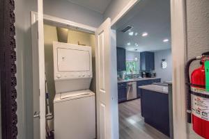 a kitchen with a washer and dryer in it at DT 534 Castle Shadow Cottage in New Braunfels