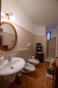 a bathroom with a sink and a toilet and a mirror at Casa Lazzaro al centro di Siena in Siena