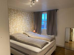 a bed with two pillows on it in a bedroom at Central Apartments in Vestmannaeyjar