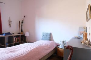 a bedroom with a bed and a table with a lamp at Haus Blang Einzelzimmer in Innsbruck