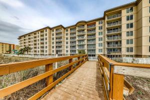 a boardwalk leading to a large apartment building at Island Princess 704 in Fort Walton Beach