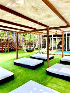 a room with three beds on the grass at MIRADOR DE BARU in Cartagena de Indias