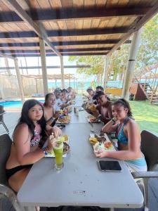 a group of people sitting at a table eating food at MIRADOR DE BARU in Cartagena de Indias