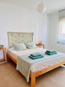 a bedroom with a bed with two towels on it at MiMar Jávea in Jávea
