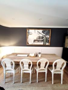 a dining room with a wooden table and four chairs at Artist Vintage Apartment near Center and Beaches in Esplugues de Llobregat