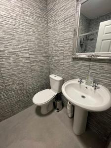 a bathroom with a toilet and a sink at Hosted By Ryan - 2 Bedroom Apartment in Liverpool