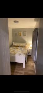 a bedroom with a white bed in a room at Ramulligan Cottage in Cavan
