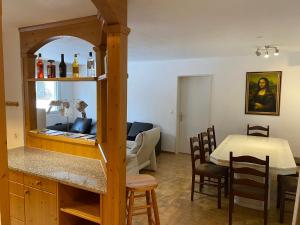 a kitchen and living room with a table and a dining room at St. Moritz in St. Moritz