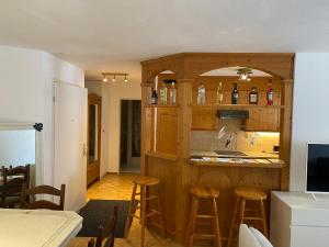 a kitchen with a bar with stools in a room at St. Moritz in St. Moritz