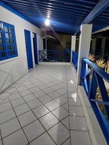 a balcony of a house with a blue railing at CASA DA NINA in Tamandaré