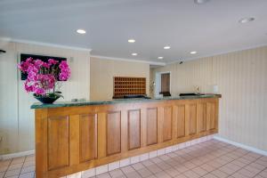 a lobby with a counter with pink flowers on it at Sahara Motel in Ocean City