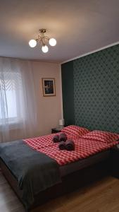 a bedroom with a bed with a teddy bear on it at Apartament w Centrum Cichy Zakątek in Gliwice