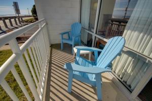 two blue chairs sitting on the porch of a house at Sahara Motel in Ocean City