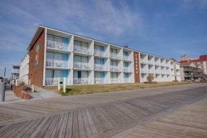 a large apartment building on the beach with a boardwalk at Sahara Motel in Ocean City