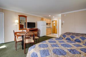 a hotel room with two beds and a table and chairs at Sahara Motel in Ocean City