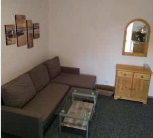 a living room with a couch and a table at Ubytování v Plumlově in Plumlov