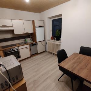 a small kitchen with a table and a dining room at Ferienwohnung Solebad in Gmünd