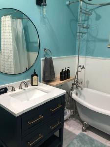 a bathroom with a sink and a tub and a mirror at Yellowstone Hideaway in Livingston +5 photos