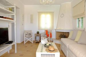 a living room with a couch and a table at Valea Villa in Agios Prokopios