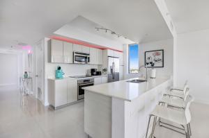 a white kitchen with white cabinets and white appliances at BeachWalk Resort #2902 - WATERFRONT RESORT HOME with DIRECT OCEAN VIEW in Hallandale Beach