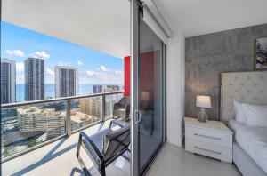 a bedroom with a bed and a balcony with a view at BeachWalk Resort #2902 - WATERFRONT RESORT HOME with DIRECT OCEAN VIEW in Hallandale Beach