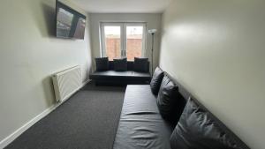 a living room with a couch and a window at Hosted By Ryan - 2 Bedroom Apartment in Liverpool