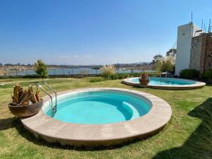 a small pool in the middle of a yard at Dos Aguas Hotel Boutique in Encinillas
