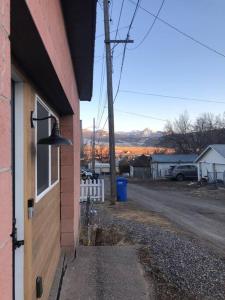 a building with a bell on the side of a street at Downtown Yellowstone Bungalow in Livingston