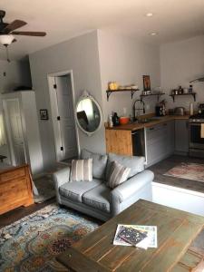 a living room with a couch and a table at Downtown Yellowstone Bungalow in Livingston