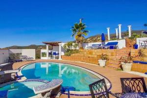 a swimming pool in a yard with chairs around it at 8 ACRES, Heated Salt Pool, Spa, Skyline Views, Mini-golf, Horseshoes, B-Ball Court, Hilltop Resort in Jamul