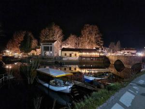 a couple of boats sitting in the water at night at Lux Apartment Sunset in Virpazar