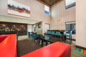 a restaurant with red chairs and tables and a bar at Best Western Bradbury Inn & Suites in Perry