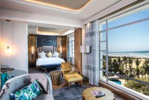 a hotel room with a bed and a view of the ocean at Suncoast Hotel & Towers in Durban +43 photos