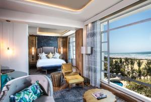 a hotel room with a bed and a view of the ocean at Suncoast Hotel & Towers in Durban