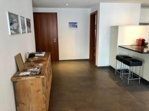 a room with a desk and a counter with stools at Aiolos Apartments 6 Personen in Zermatt