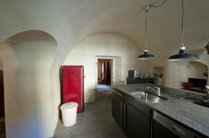 a kitchen with a red refrigerator and a sink at Chasa Florinja in Scuol