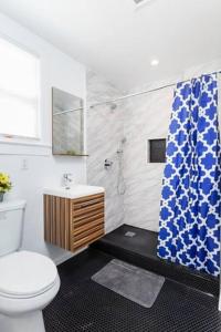 a bathroom with a toilet and a shower curtain at Cheerful Affordable Private Rooms Shared Bath near SFO - UP in South San Francisco