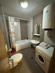 a bathroom with a toilet and a sink and a tub at Ania apartment in Podgorica +22 photos