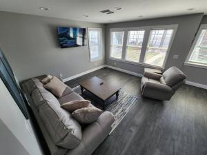 a living room with a couch and two chairs at Paradise on Lake Harris Apt #202 in Leesburg