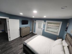 a bedroom with a bed and a blue wall at Paradise on Lake Harris Apt #202 in Leesburg
