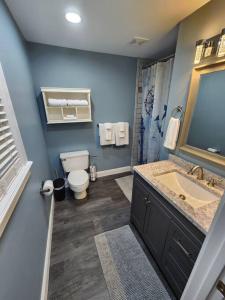 a blue bathroom with a toilet and a sink at Paradise on Lake Harris Apt #202 in Leesburg