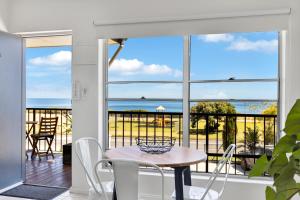 a dining room with a view of the ocean at Coast Motel and Apartments in Port Noarlunga