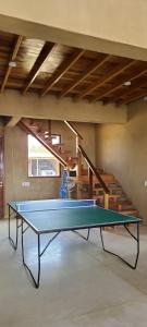 a ping pong table in a room with a staircase at Casa Villa Alive - Vichayito Sur, Los Organos Talara in San Martín