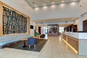 a lobby of a hospital with a counter and chairs at Holiday Inn Mobile Airport by IHG in Mobile +37 photos